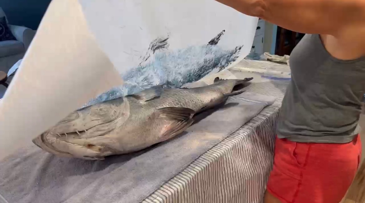 Bridget holding up a finished gyotaku fish print