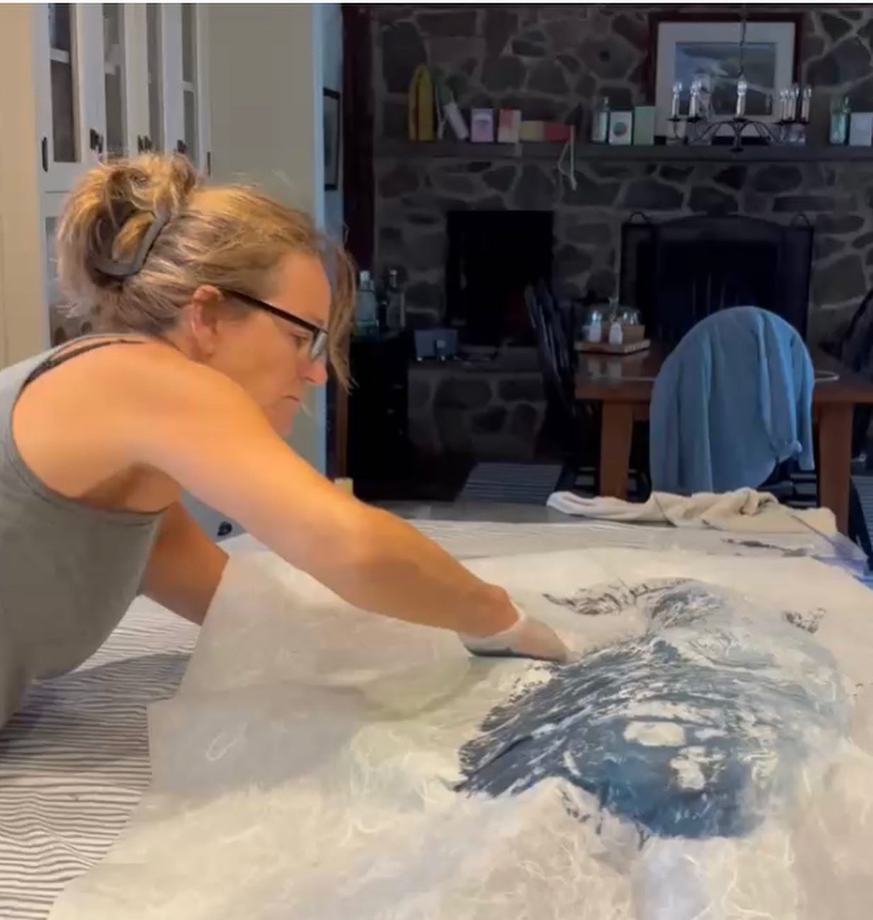 Bridget pressing rice paper over an inked fish