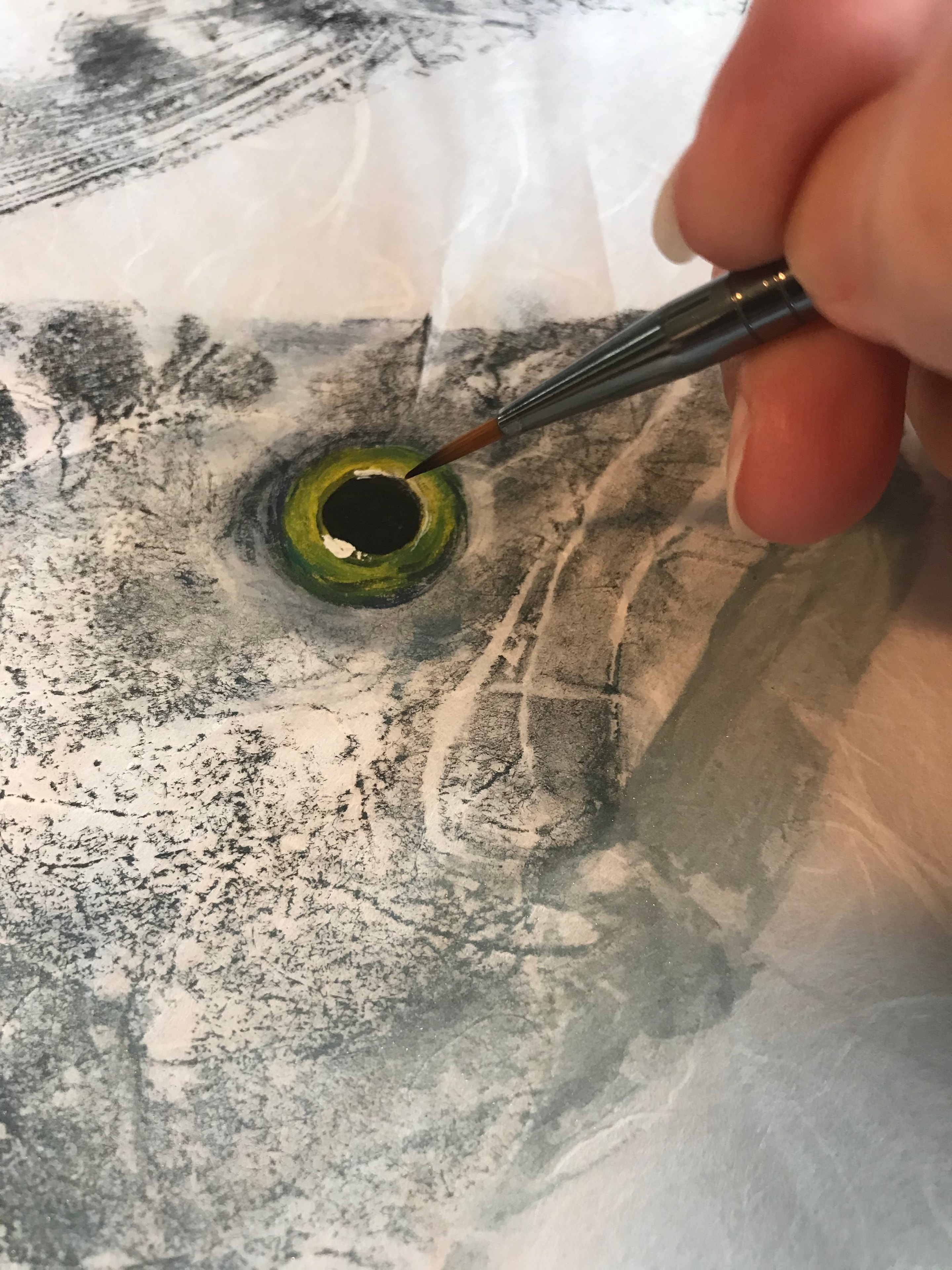 Bridget adding fine detail and color to a finished print